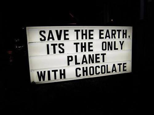 A church sign reads 'Save the Earth, it's the only planet with chocolate'